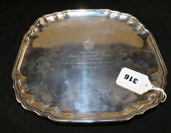 Square silver salver, pie crust edge, on four scroll feet